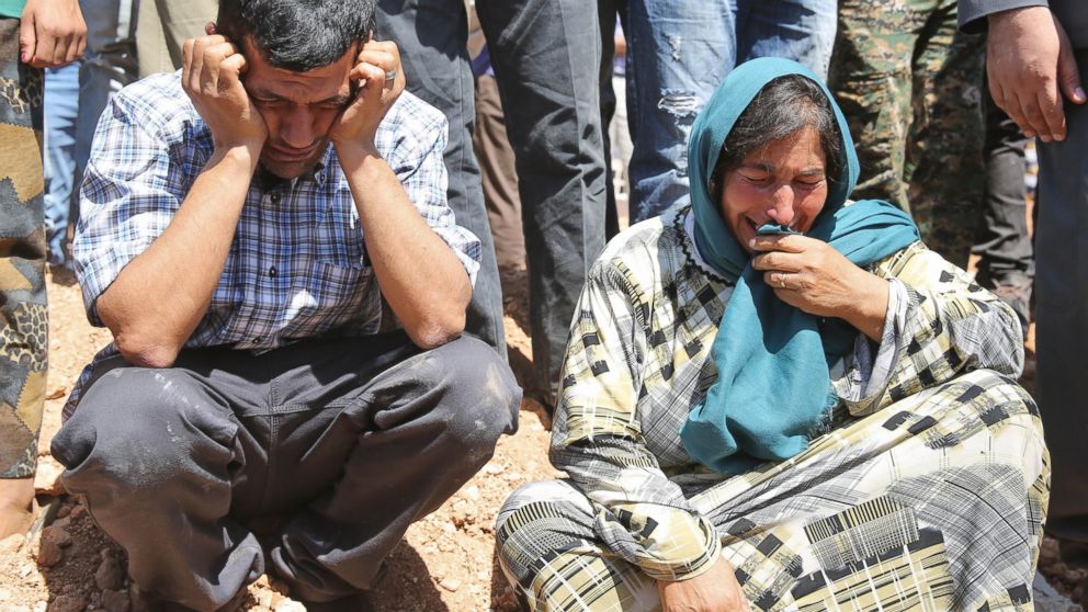 Abdullah Kurdi mourns during funeral of his family, Sept. 4, 2015, in the Syrian border town of Kobani.