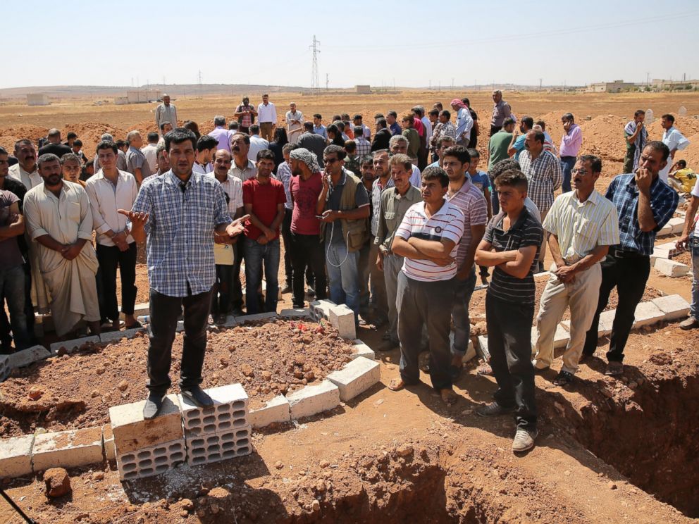 PHOTO:Abdullah Kurdi, father of Syrian children Aylan,  Galip, and husband of Rehan Kurdi, 27, speaks during the funeral of his family in the Syrian border town of Kobani, Sept. 4, 2015.  