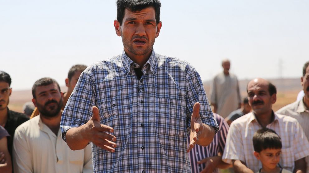 PHOTO: Abdullah Kurdi, father of Syrian children Aylan, Galip, and husband of Rehan, speaks during the funeral of his family in the Syrian border town of Kobani, Sept. 4, 2015. 