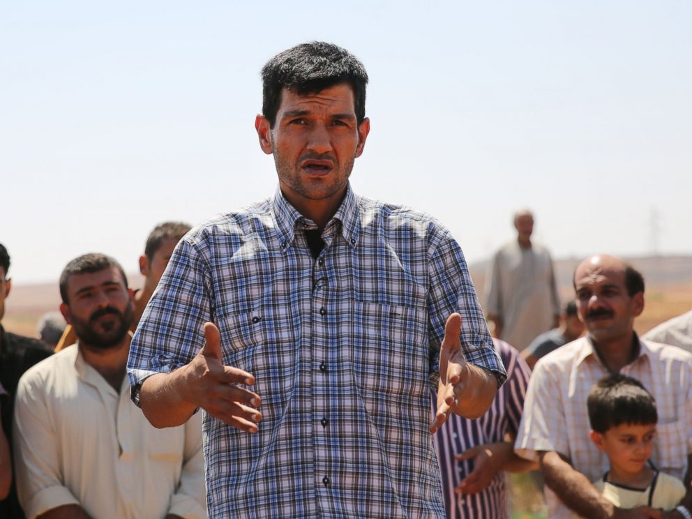 PHOTO: Abdullah Kurdi, father of Syrian children Aylan, Galip, and husband of Rehan, speaks during the funeral of his family in the Syrian border town of Kobani, Sept. 4, 2015.