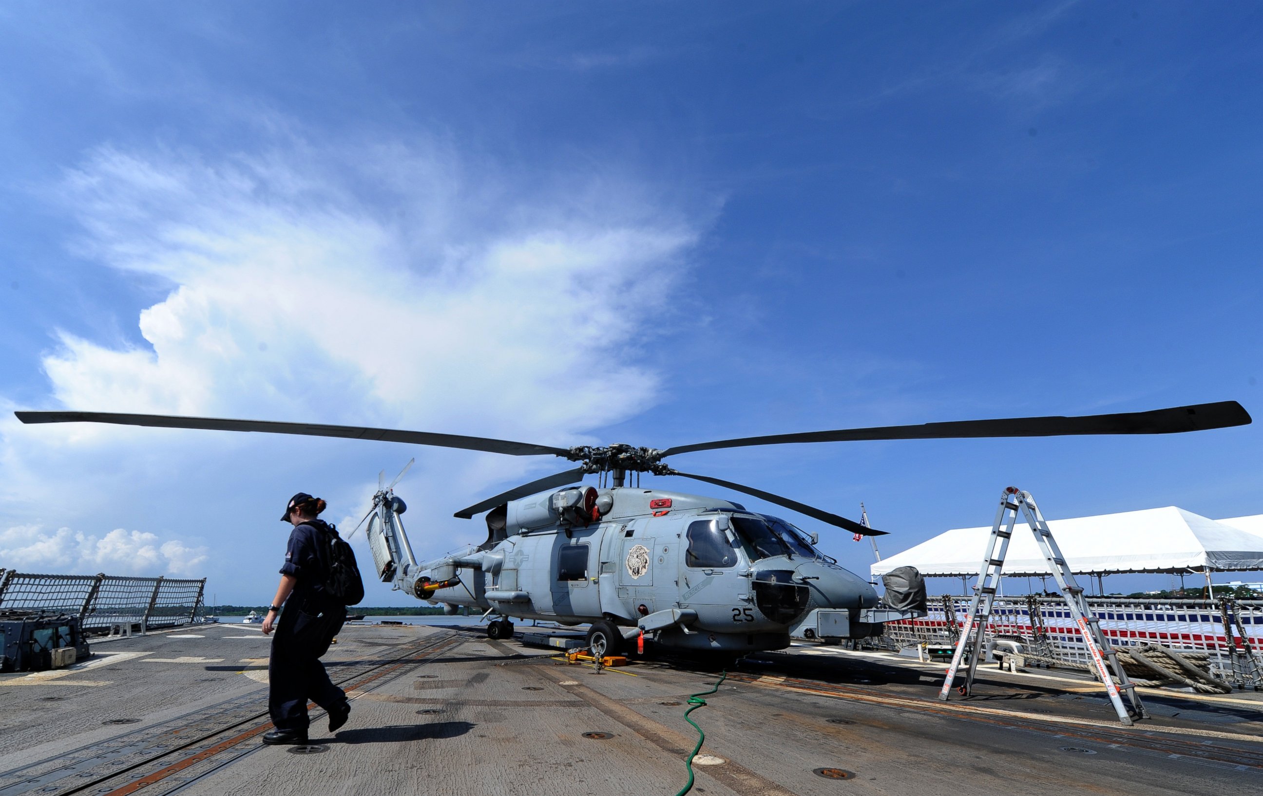 PHOTO: A US navy officer walks past a SeaHawk on board the guided missile destroyer USS Howard docked near the disputed Spratly islands, June 29, 2011. 