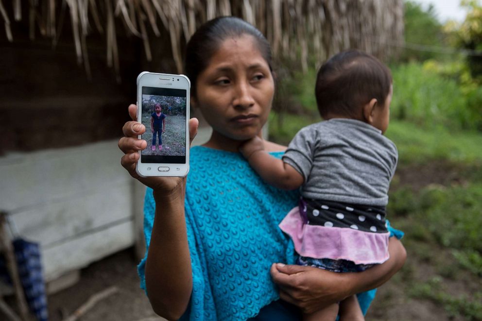 PHOTO: Claudia Maquin, 27, shows a photo of her daughter, Jakelin Amei Rosmery Caal Maquin in Raxruha, Guatemala, Dec. 15, 2018.