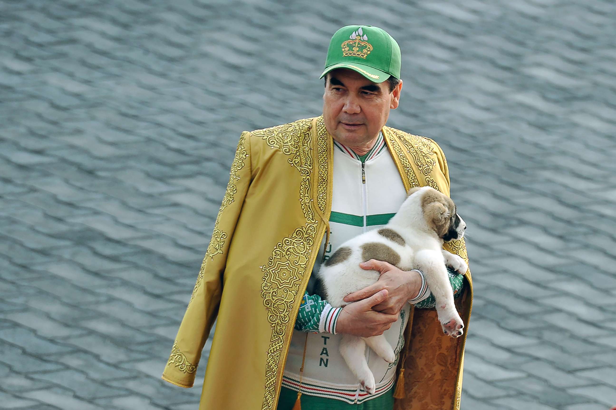 PHOTO: Turkmenistan's President Gurbanguly Berdymukhamedov holds a Turkmen shepherd dog, locally known as Alabai, as he takes part in celebrations for the Day of the Horse in Ashgabat, April 28, 2018.