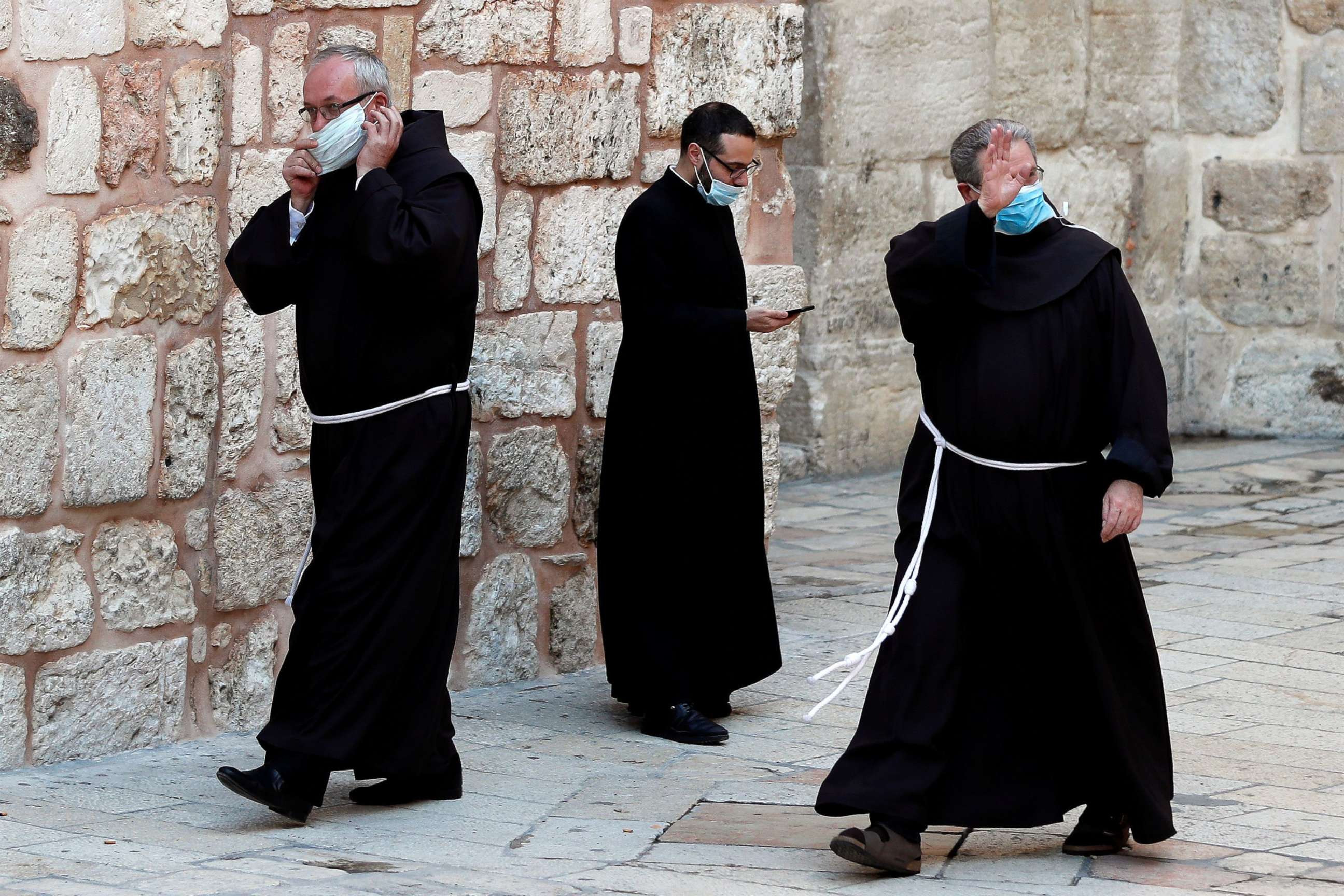 PHOTO: Franciscan friars wearing masks prepare before entering the Church of the Holy Sepulchre to participate in the Easter Sunday service amid the coronavirus disease (COVID-19) outbreak, in Jerusalem's Old City April 12, 2020.