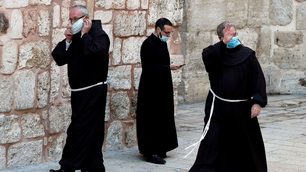 PHOTO: Franciscan friars wearing masks prepare before entering the Church of the Holy Sepulchre to participate in the Easter Sunday service amid the coronavirus disease (COVID-19) outbreak, in Jerusalem's Old City April 12, 2020.