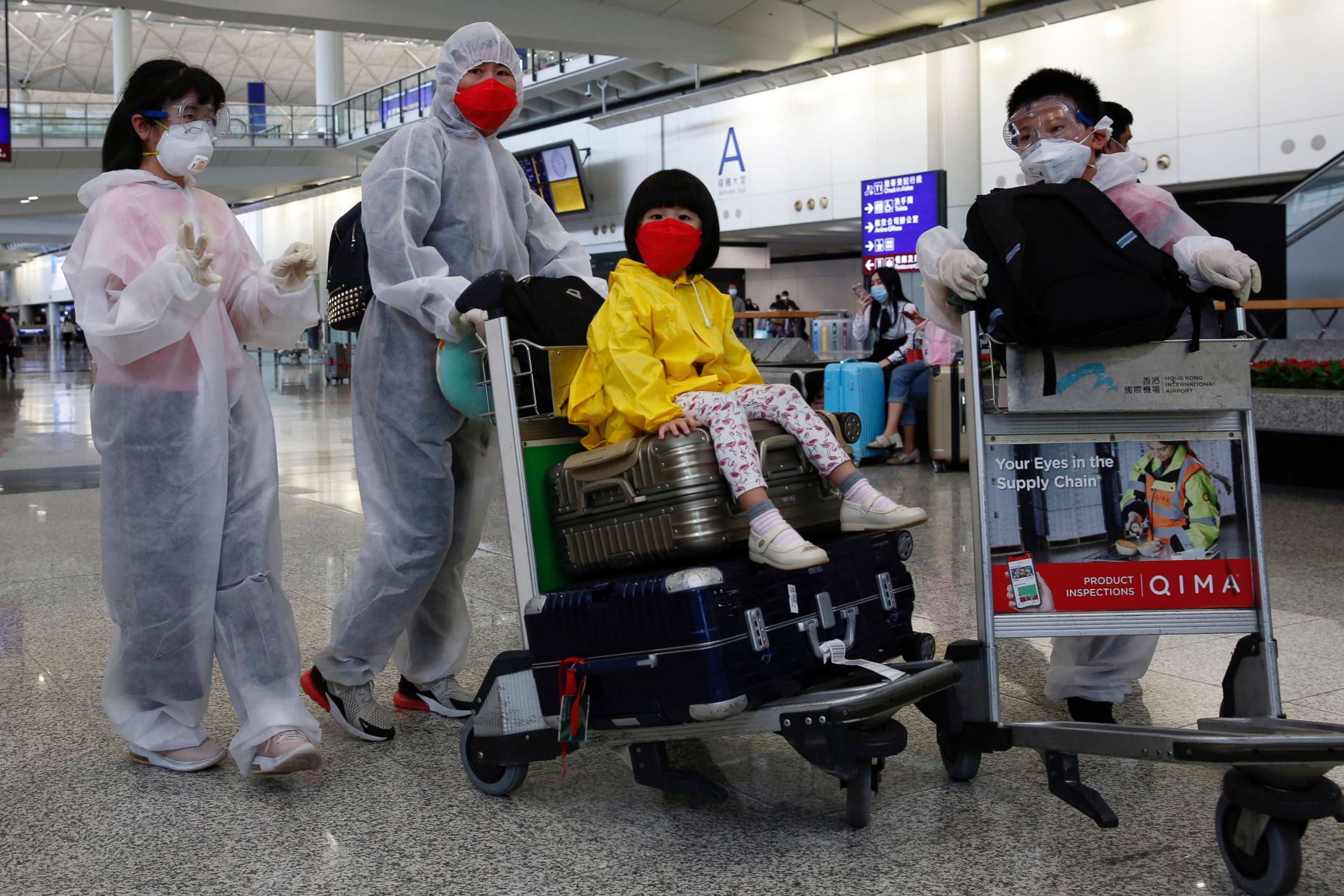 PHOTO: Passengers wear protective suits, amid the outbreak of coronavirus, at Hong Kong International Airport, Hong Kong, China March 17, 2020.