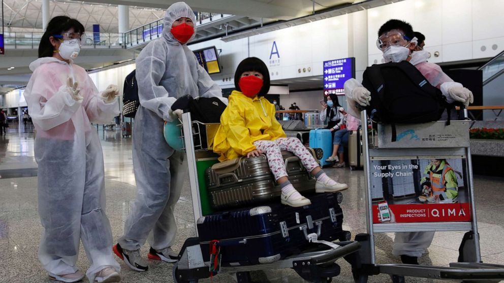 PHOTO: Passengers wear protective suits, amid the outbreak of coronavirus, at Hong Kong International Airport, Hong Kong, China March 17, 2020.