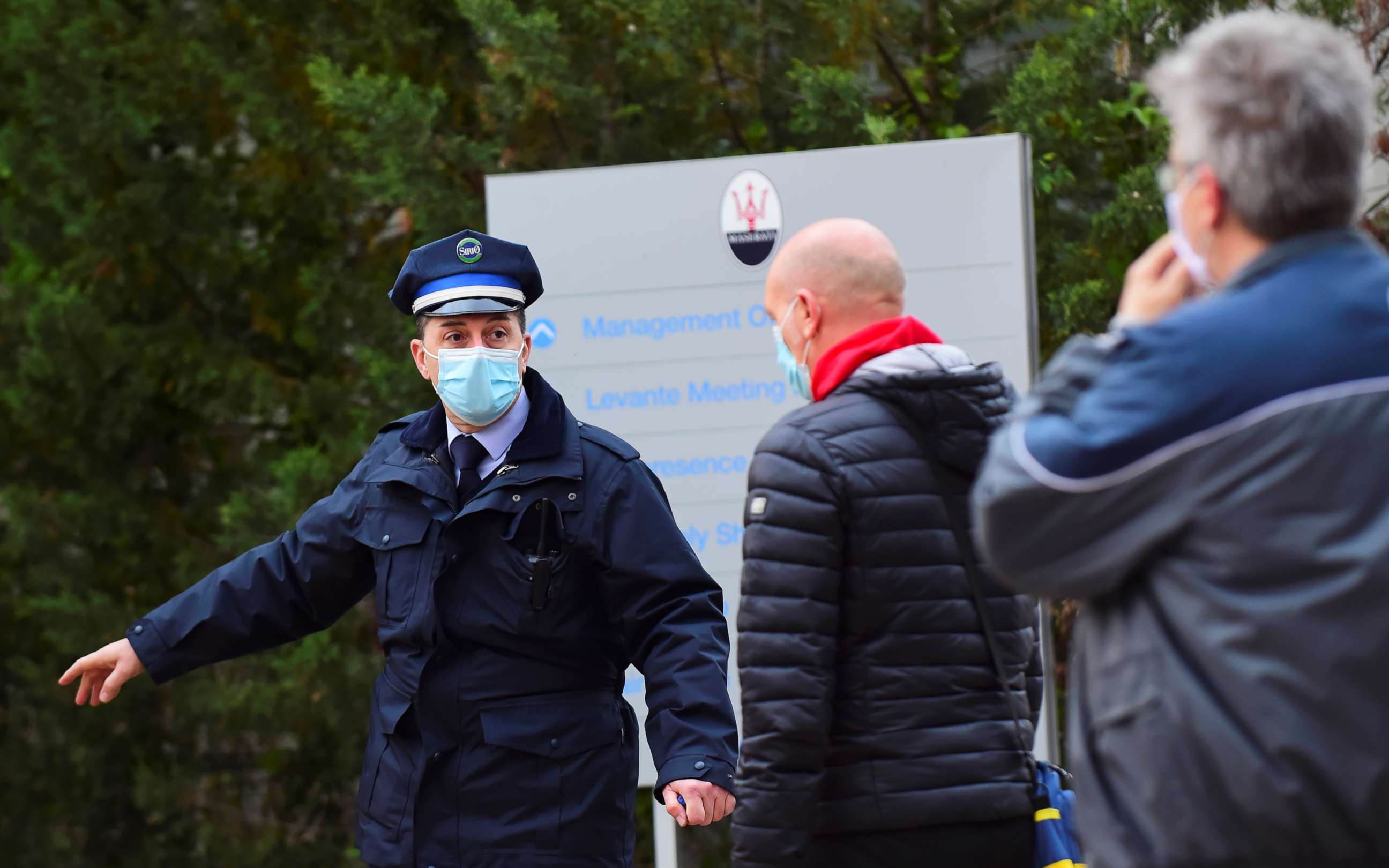 PHOTO: An employee gestures as people enter the FCA Mirafiori plant as it resumes its operations after closure during a lockdown amid the coronavirus disease (COVID-19) outbreak in Turin, Italy April 27, 2020.