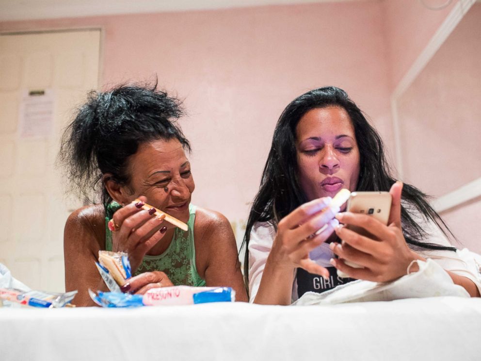 PHOTO: Liset and Marta talk with friends from a hotel room in Brazil.