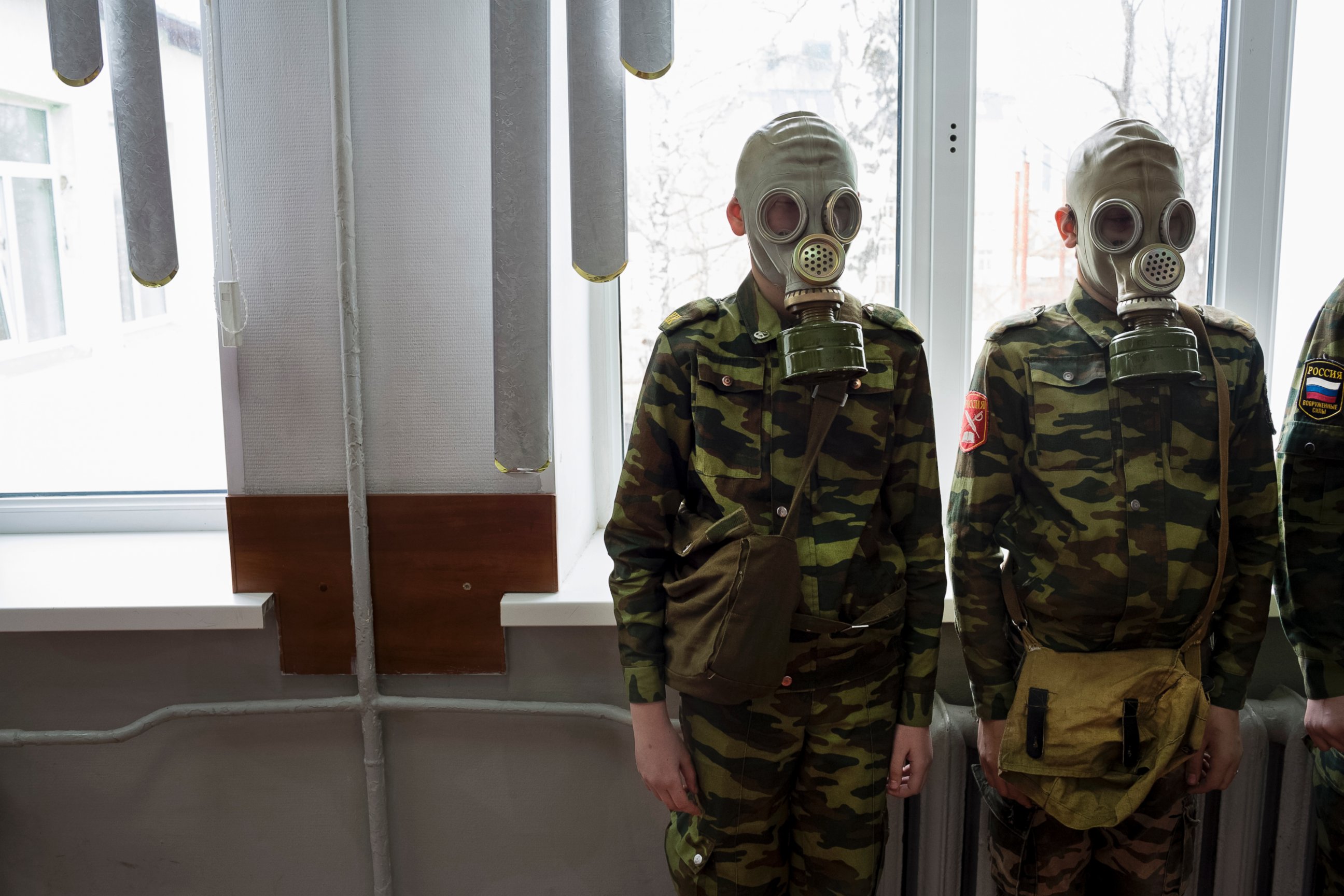 PHOTO: Students stand ready as a teacher observes how quickly they can dress in gas masks, April 4, 2016, at School #7 in Dmitrov, Russia.