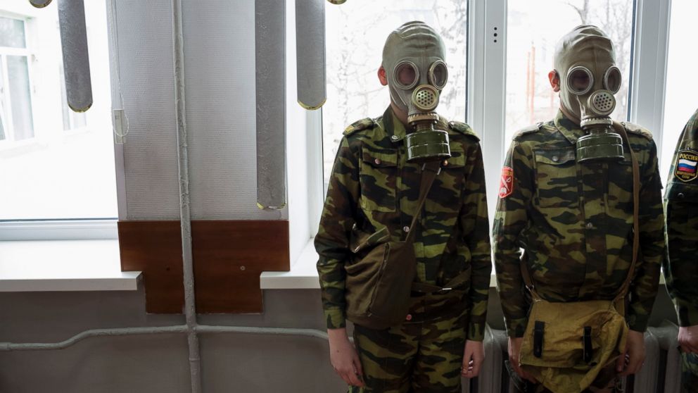 PHOTO: Students stand ready as a teacher observes how quickly they can dress in gas masks, April 4, 2016, at School #7 in Dmitrov, Russia.