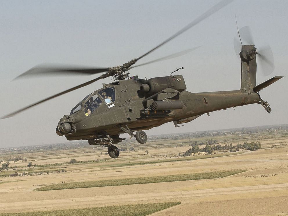 PHOTO: The Boeing AH-64 Apache is a four-blade, twin-engine attack helicopter with a tailwheel-type landing gear arrangement, and a tandem cockpit for a two-man crew.