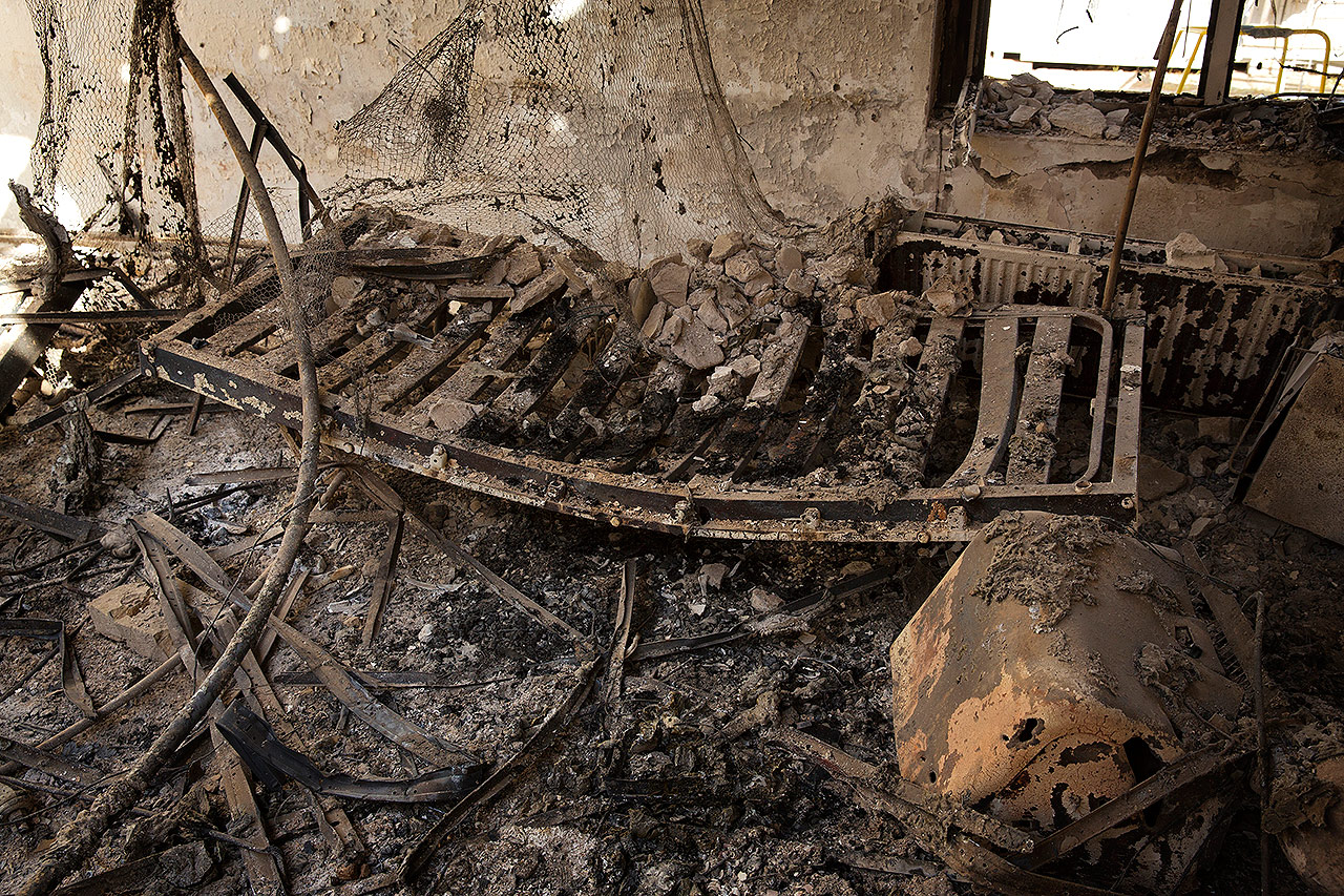 PHOTO: A charred and twisted bed-frame lies among ashes in a burnt room inside the MSF hospital in Kunduz hit by U.S. airstrikes on October 3, 2015.