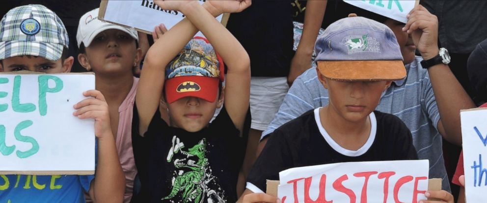 PHOTO: Refugee children take part in a protest in March 2015 against their resettlement on Nauru and living conditions on the island.
