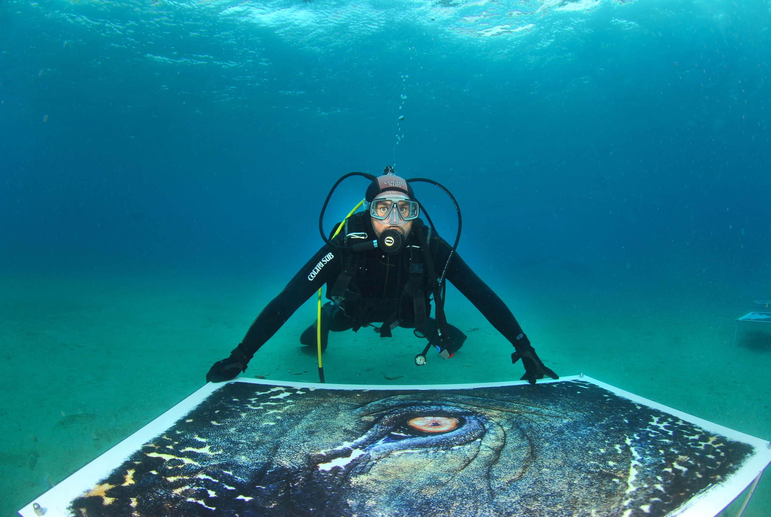 PHOTO: Artist Salvo Galano installs the underwater exhibition.