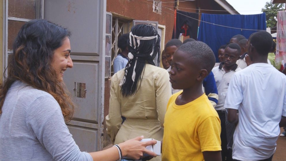 PHOTO: Actress Lupita Nyong'o and The Soular Backpack CEO, Salima Visram at a backpack distribution event in Katwe, Uganda. 