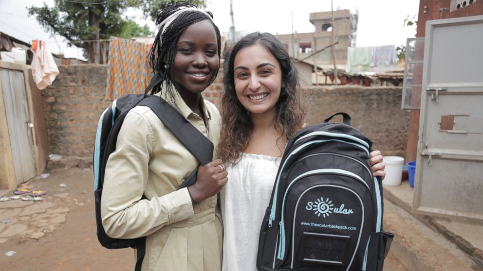 PHOTO: Actress Lupita Nyong'o and The Soular Backpack CEO, Salima Visram at a backpack distribution event in Katwe, Uganda. 