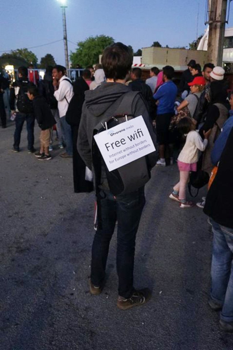 PHOTO: Project Open Network volunteer carrying a wifi hotspot amid the crowd of refugees and migrants in Opatovac camp, near the town of Tovarnik, Croatia, on September 21nd. 