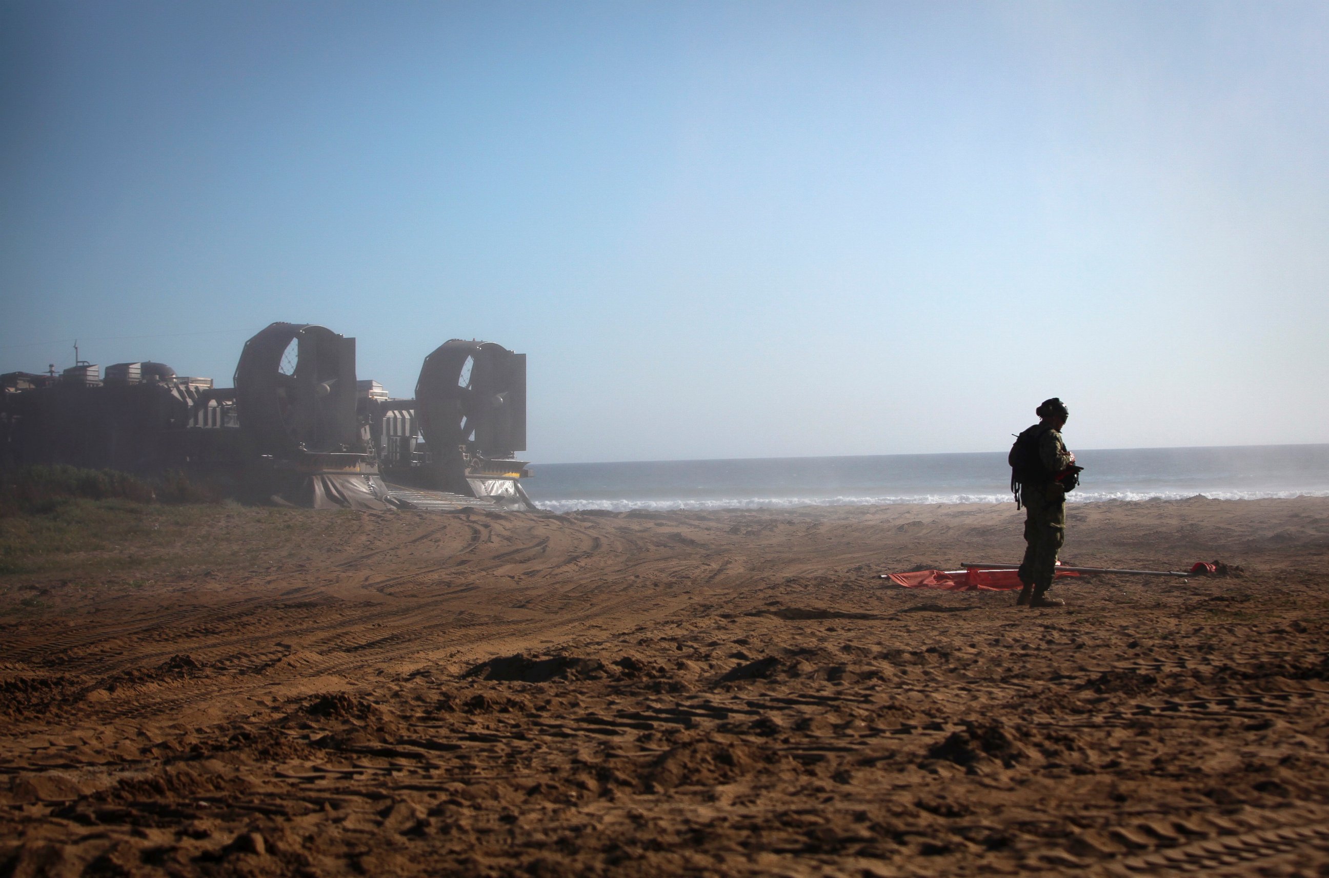 PHOTO: U.S. Navy Gunner's Mate 3rd Class Dakota Griffin waits for personnel to debark a landing craft, air cushion onto a beach landing site aboard Camp Pendleton Calif., during Composite Training Unit Exercise (COMPTUEX) March 27, 2015.