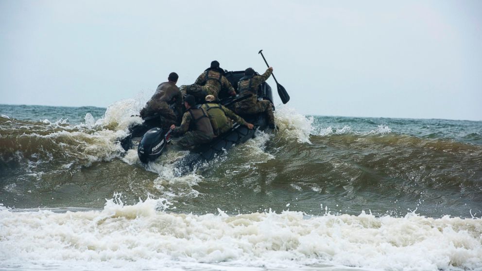 PHOTO: Members of the Army National Guard's 20th Special Forces Group (Airborne) enter the water at Naval Station Mayport, Fla., April 29, 2015.