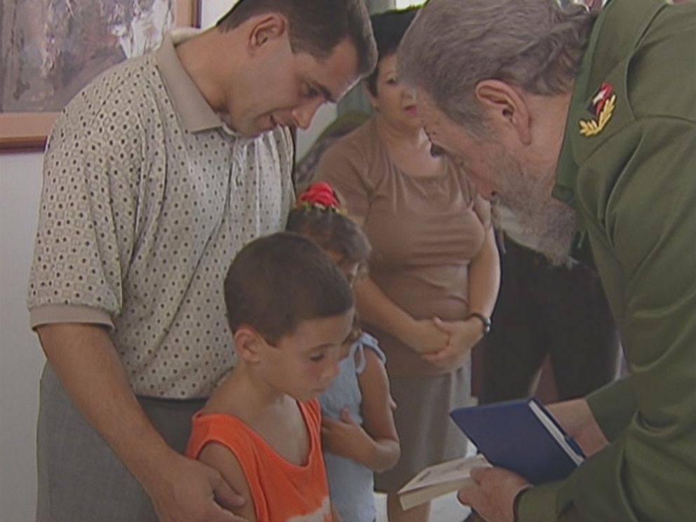 Elian Gonzalez is shown here as a young boy accepting a copy of "La Edad de Oro" by Jose Marti, given to him and signed by former Cuban president Fidel Castro. 