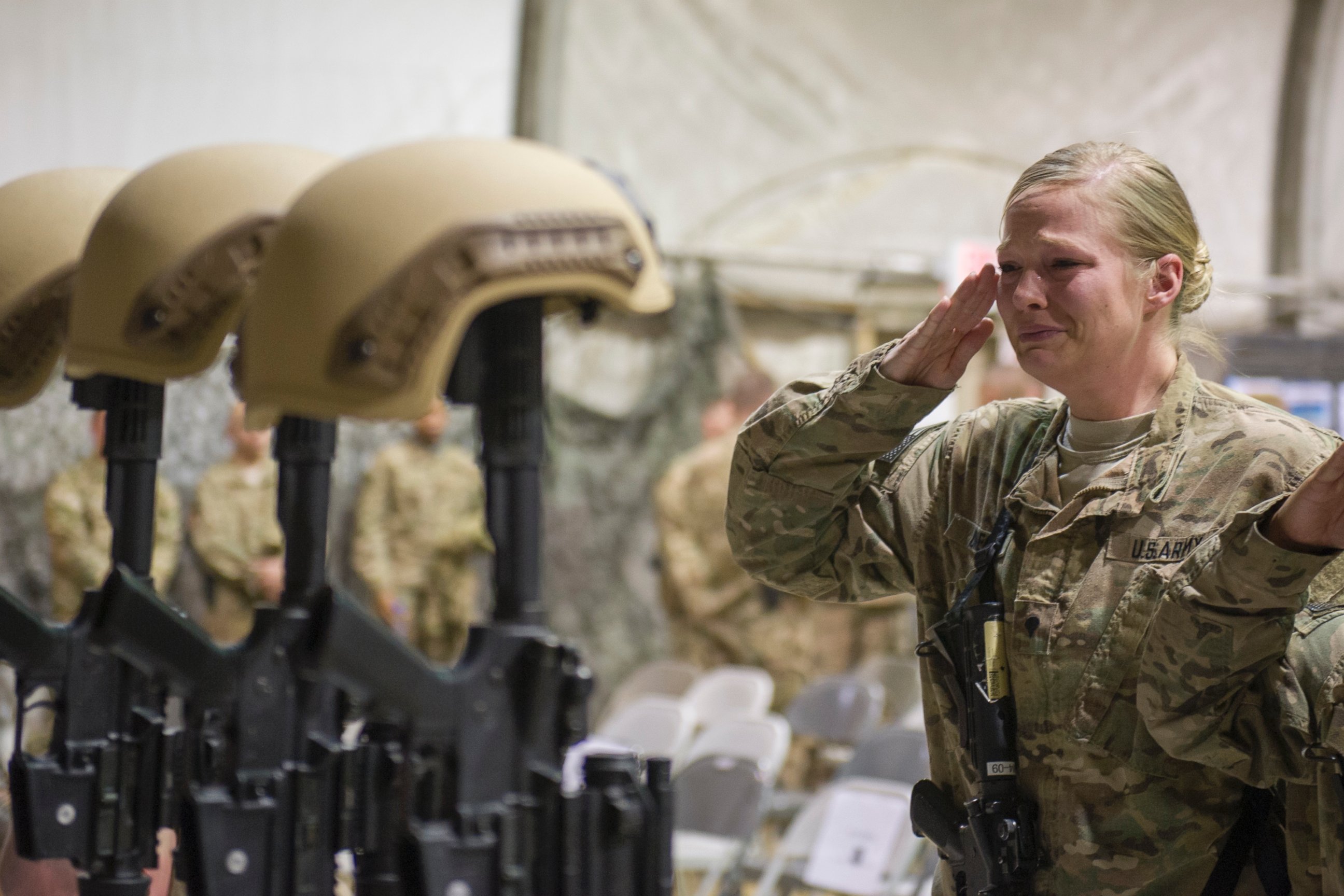 PHOTO: Service members from several units at Bagram Air Field, Afghanistan, pay their respects during a fallen comrade ceremony held in honor of six Airmen, Dec. 23, 2015.  
