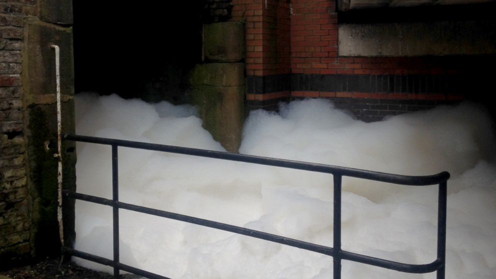 A wall of foam appeared on a canal in northern England, April 5, 2015, after firefighters battled a blaze at a chemical plant.