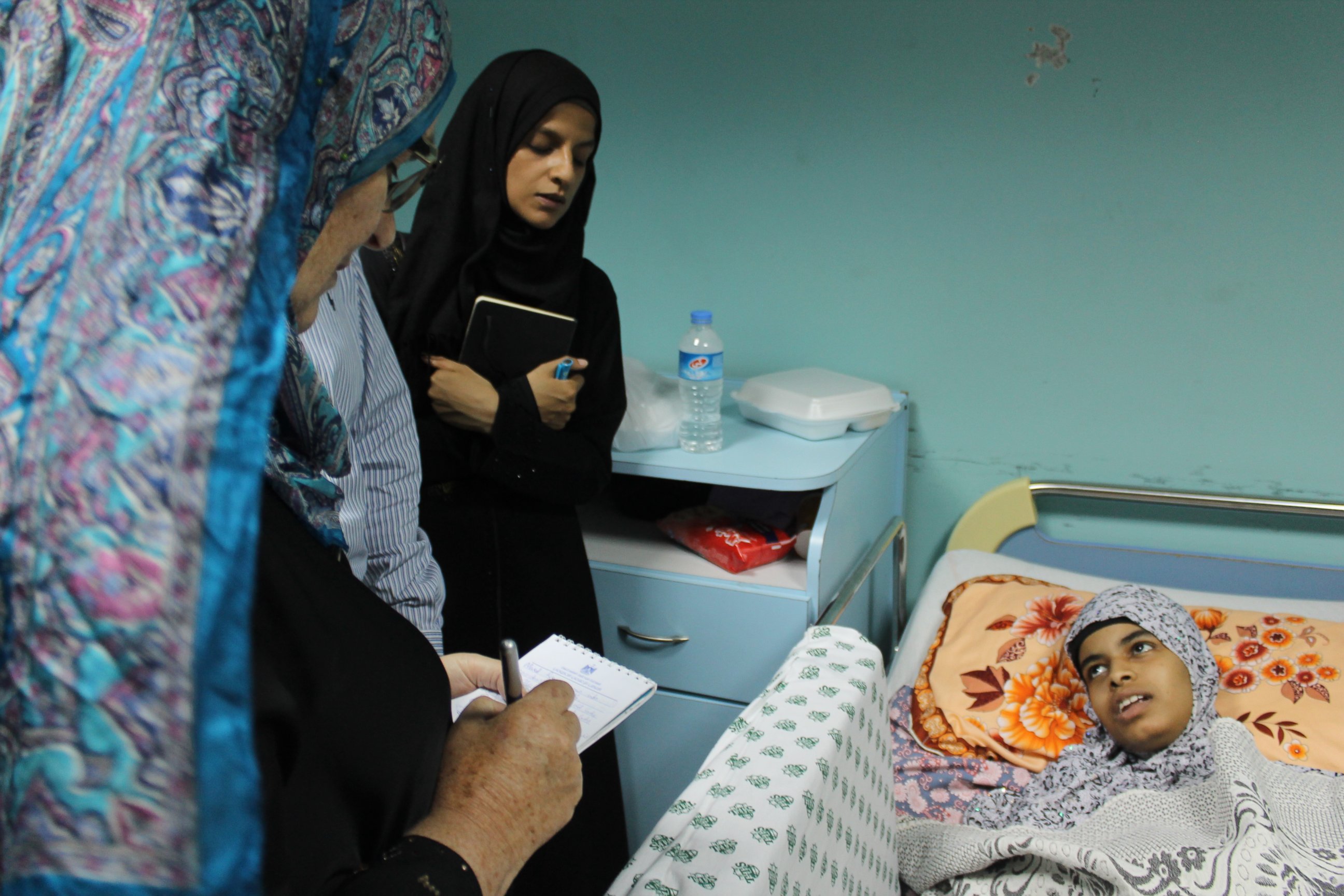 PHOTO: International activists speak with a patient hours after an Israeli projectile struck the hospital's fourth floor Friday evening, demolishing a wall and damaging doors and windows.