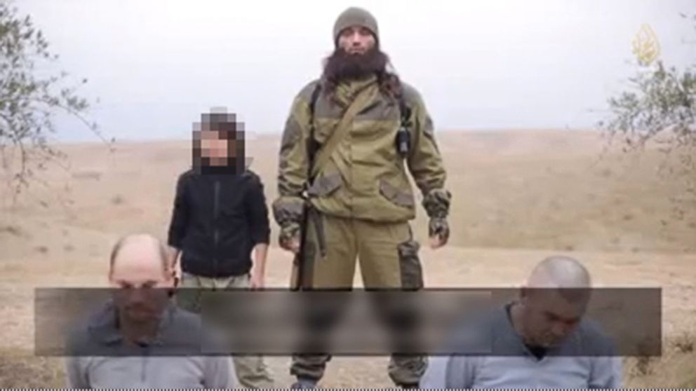 PHOTO: A video released by ISIS Jan. 13, 2015 claims to show a child killing two Russian “spies.”