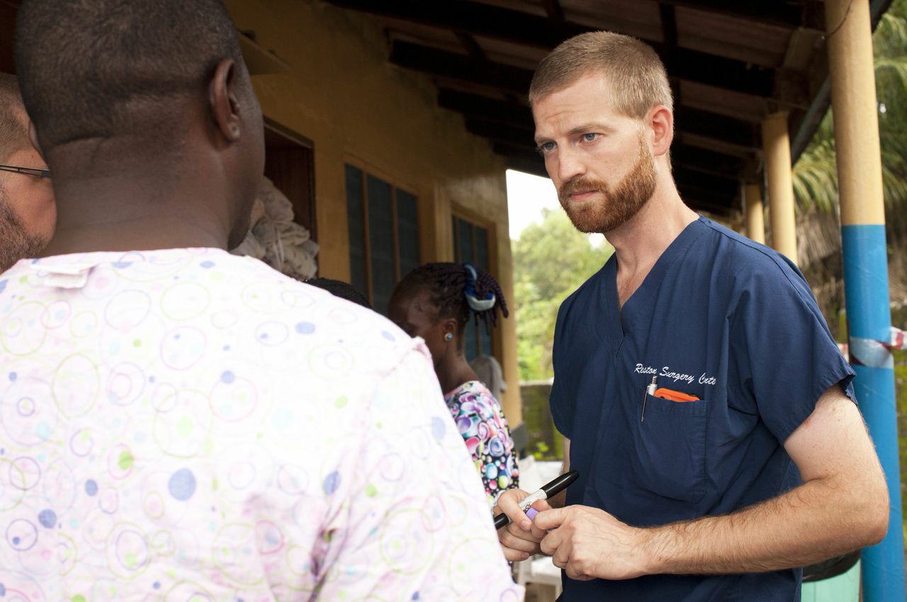 PHOTO: Dr. Kent Brantly speaks with a worker outside the ELWA Hospital in Monrovia, Liberia