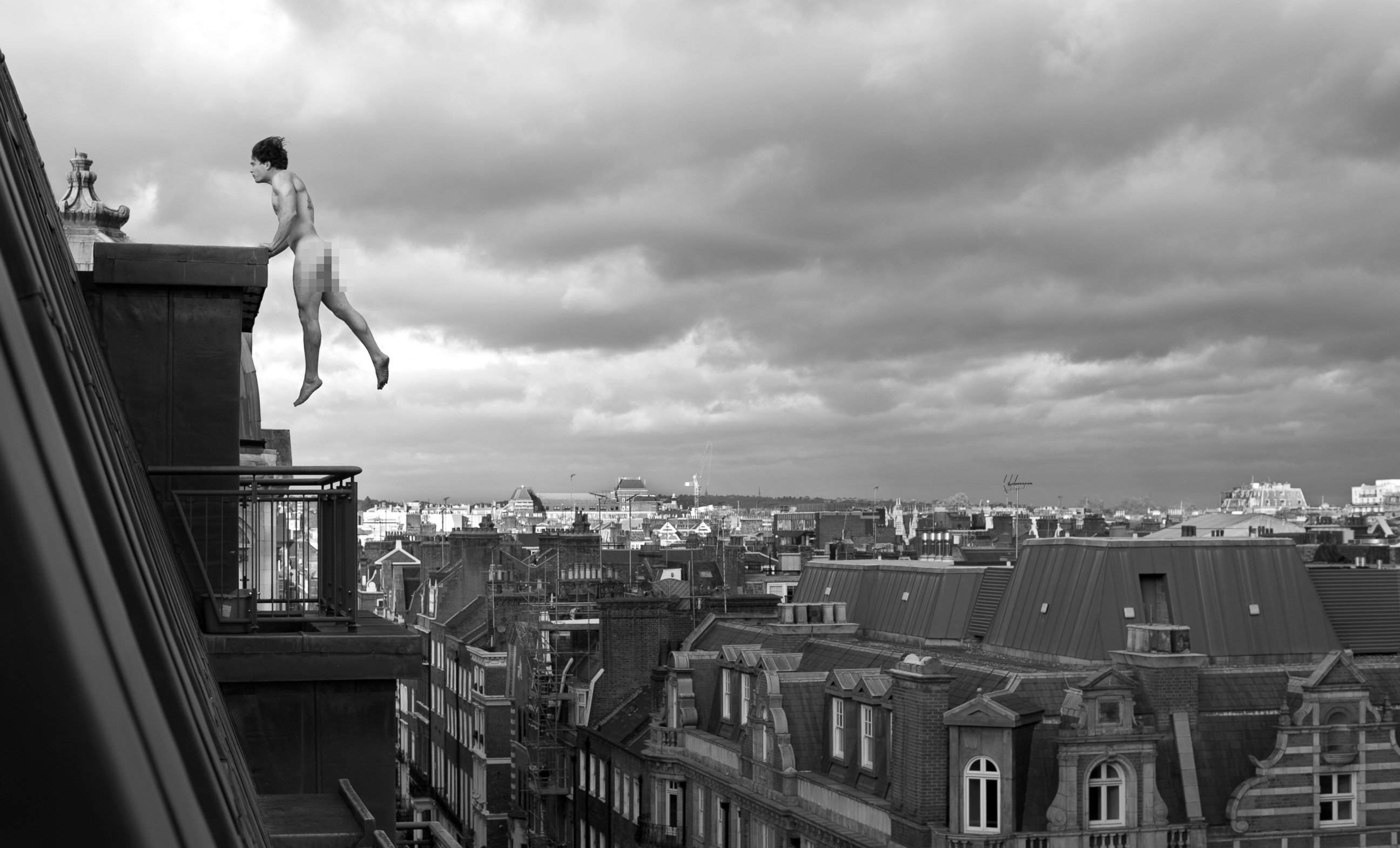 PHOTO: World Champion free runner Tim Sheiff levitates naked across high-rises in central London.