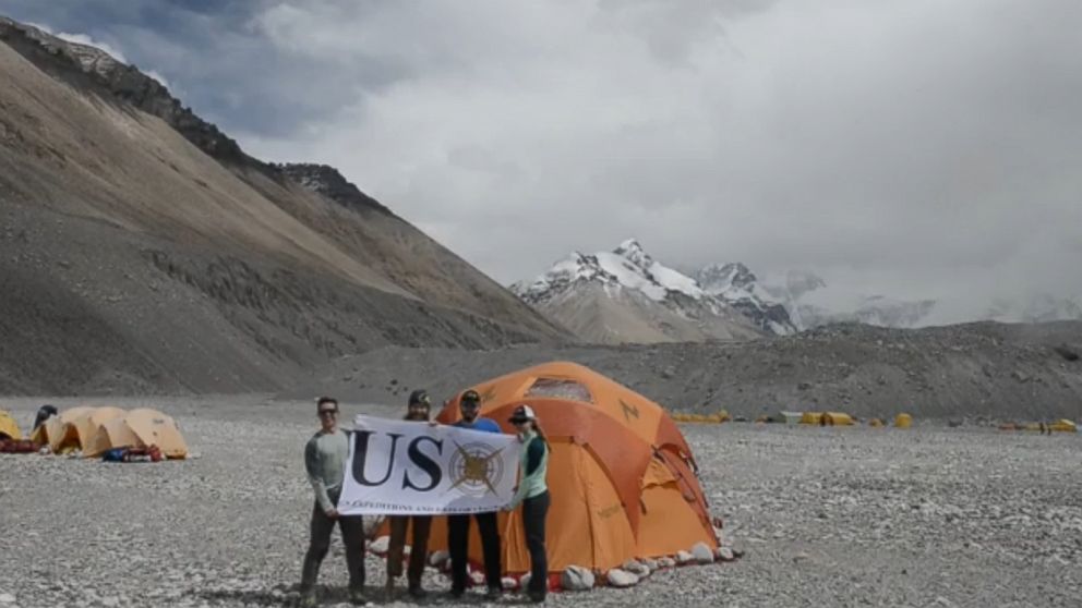 PHOTO: Members of the USX Veteran Everest Expedition hold up a banner at the base camp of Mount Everest.