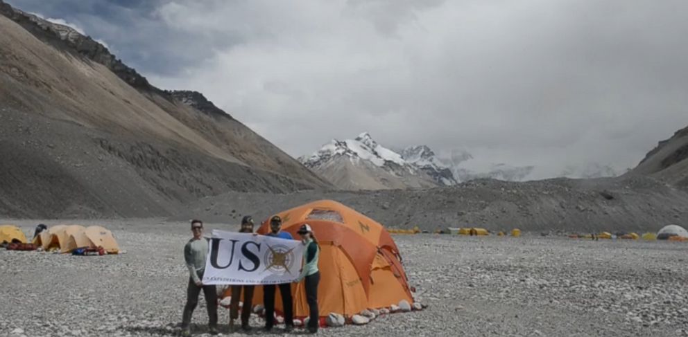 PHOTO: Members of the USX Veteran Everest Expedition hold up a banner at the base camp of Mount Everest.