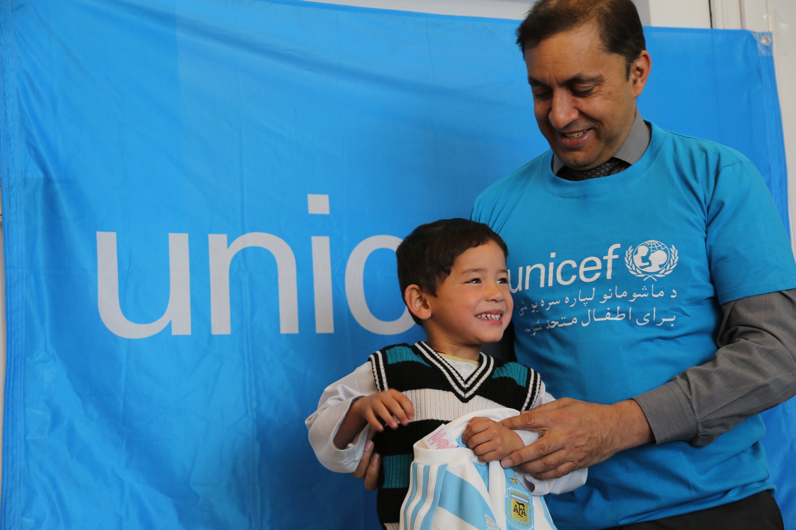 PHOTO: As of today, Murtaza Ahmadi can proudly show off the new signed jerseys and a football he received from UNICEF Goodwill Ambassador Leo Messi. Murtaza's photo went viral after he was pictured wearing a soccer jersey made from a plastic bag.