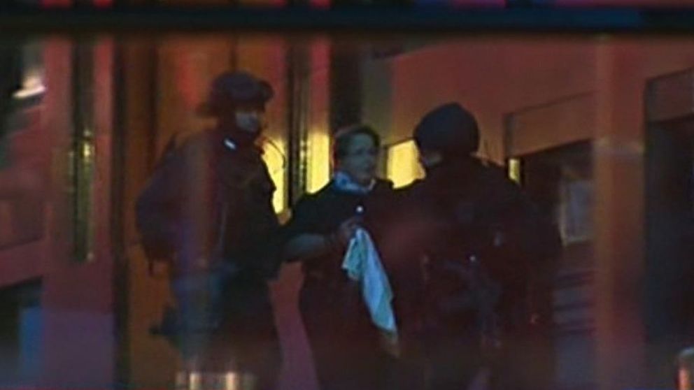 PHOTO: Hostages emerge from a cafe under siege at Martin Place in Sydney, Australia