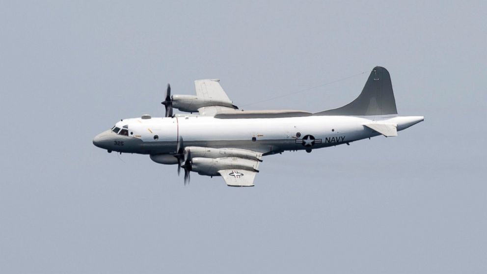 An EP-3E Aries, assigned to the "World Watchers" of Fleet Air Reconnaissance Squadron (VQ) 1, left, performs a flyby over aircraft carrier USS Harry S. Truman, April 24, 2016.