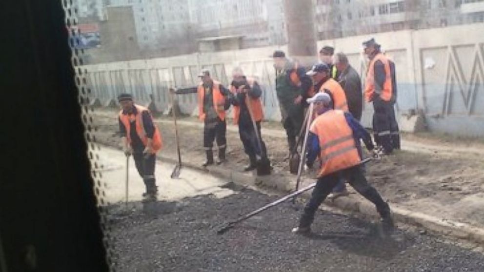 Workers resurface roads in Omsk, Russia, a day after a local woman complained to Russian President Vladimir Putin that they were in a terrible condition and authorities were doing nothing.