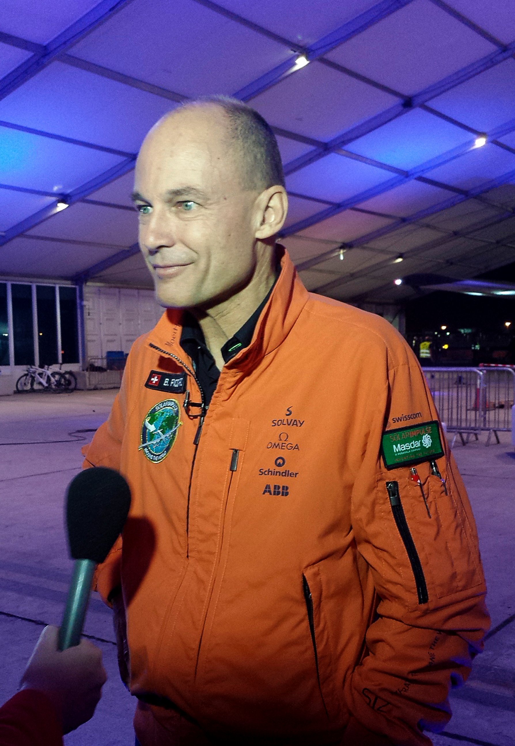 PHOTO: Solar Impulse co-founder and pilot Bertrand Piccard speaks to reporters at an airport