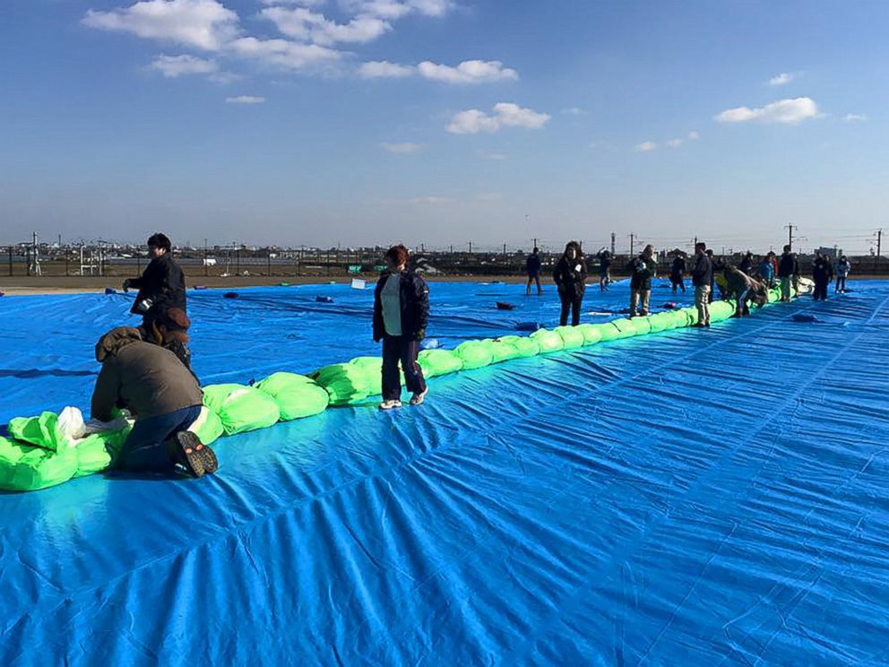 PHOTO: Japanese volunteers in Saga, Japan, help to ready the Two Eagles balloon for flight 