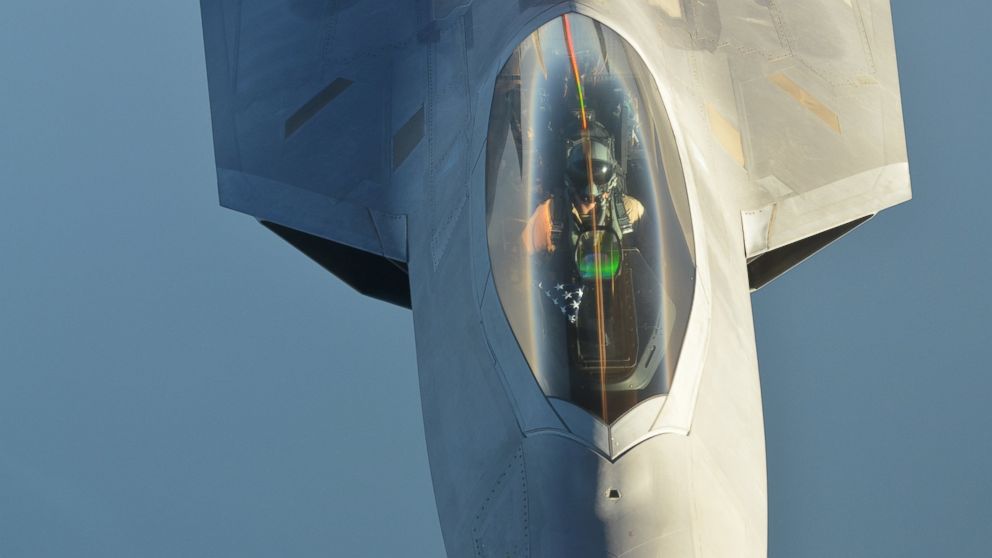 PHOTO: A U.S Air Force KC-10 Extender refuels an F-22 Raptor fighter aircraft after strikes in Syria