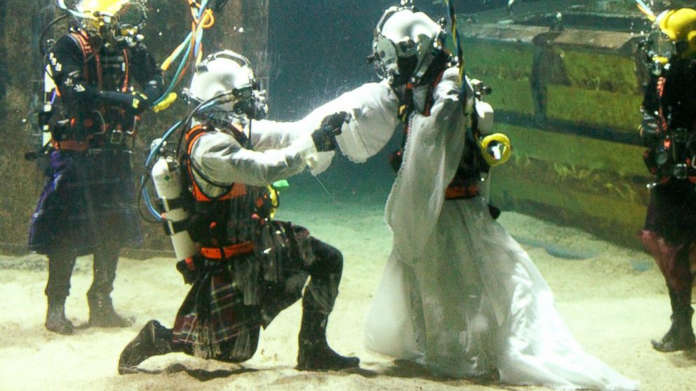 Dorota Bankowska and new husband James Abbott renew their vows underwater inside a diving tank at Fort William Underwater Center in Scotland, Nov. 22, 2014.
