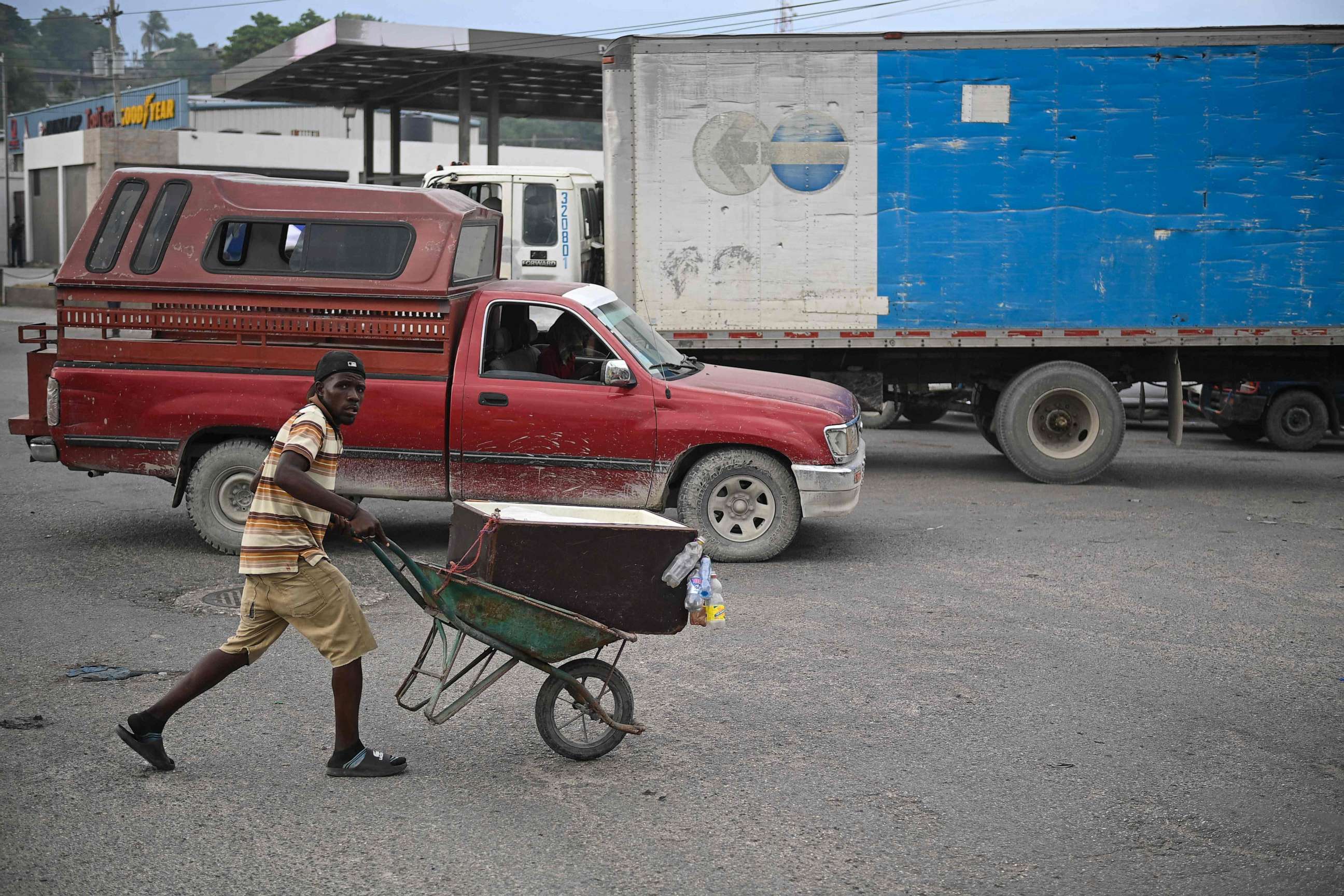 PHOTO: A man pushes a wheelbarrow in Port-au-Prince on June 28, 2023. (Photo by Richard PIERRIN / AFP) (Photo by RICHARD PIERRIN/AFP via Getty Images)