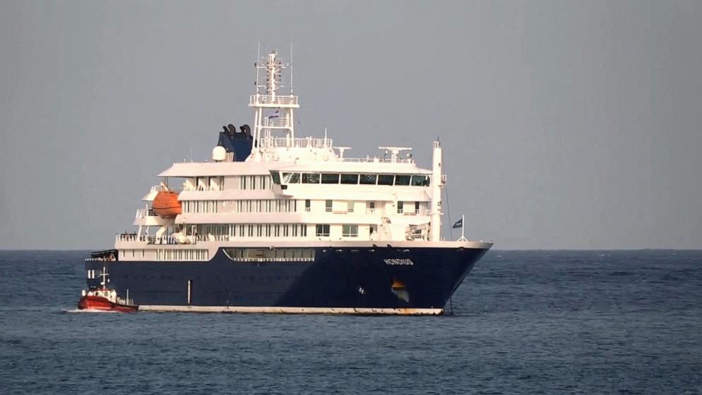 PHOTO: A boat sails beside the cruise ship, MV Hondius, hit by Hantavirus as it is anchored off Cape Verde port, in Praia Port, Cape Verde, May 5, 2026. 