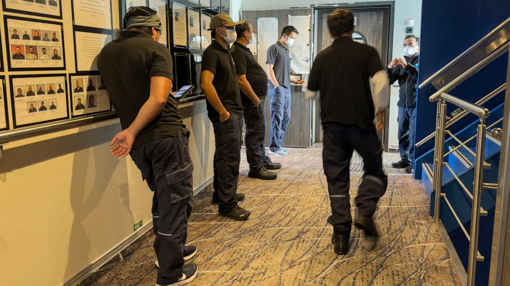 PHOTO: Crew members of the hantavirus-stricken cruise ship, MV Hondius, wait their turns for a first interview with epidemiologists, during the voyage to Spain's port of Tenerife, May 6, 2026. 