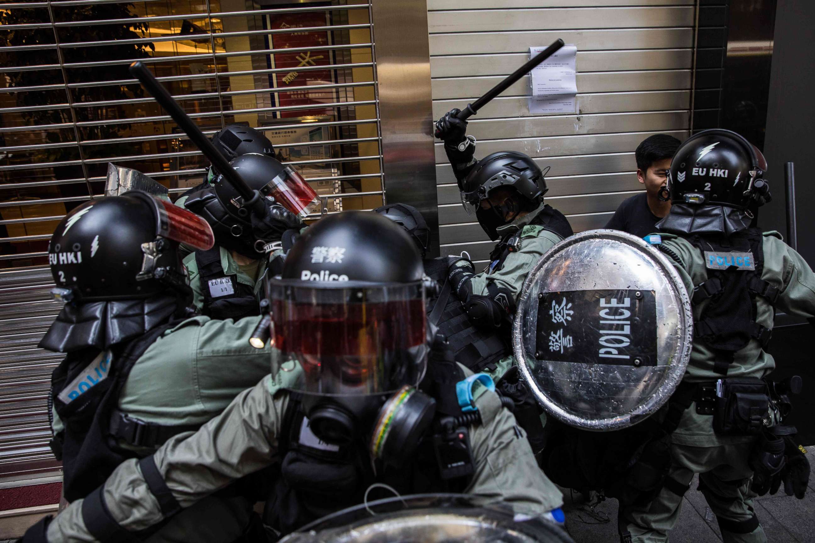 PHOTO: Riot police detain two men in the Central district of Hong Kong on November 11, 2019, as clashes ignited across the city and and crowds took to the streets to block roads and hurl insults at officers. (Photo by DALE DE LA REY/AFP via Getty Images)