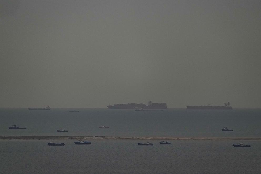 PHOTO: Fishing boats dot the sea as cargo ships sail through the Persian Gulf toward the Strait of Hormuz off the United Arab Emirates, on March 27, 2026.