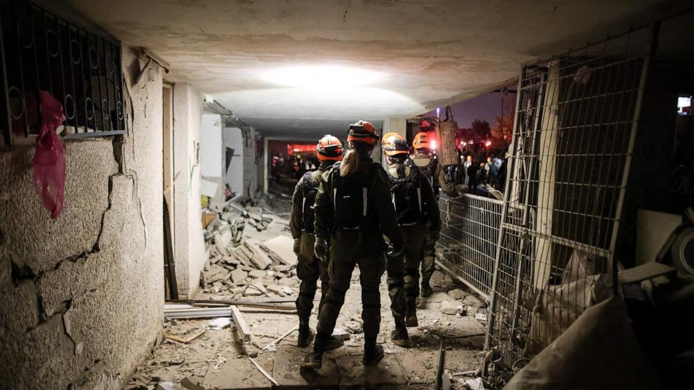 PHOTO: Israeli soldiers work at the scene of damage after Iranian missile barrages struck residential buildings in Arad, amid the U.S.-Israel conflict with Iran, in southern Israel