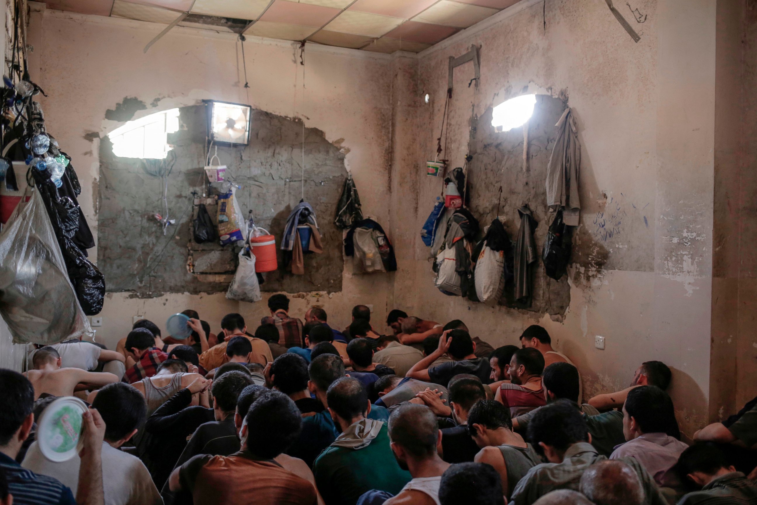 PHOTO: In this Tuesday, July 18, 2017 file photo, Suspected Islamic State members sit inside a small room in a prison south of Mosul, Iraq.
