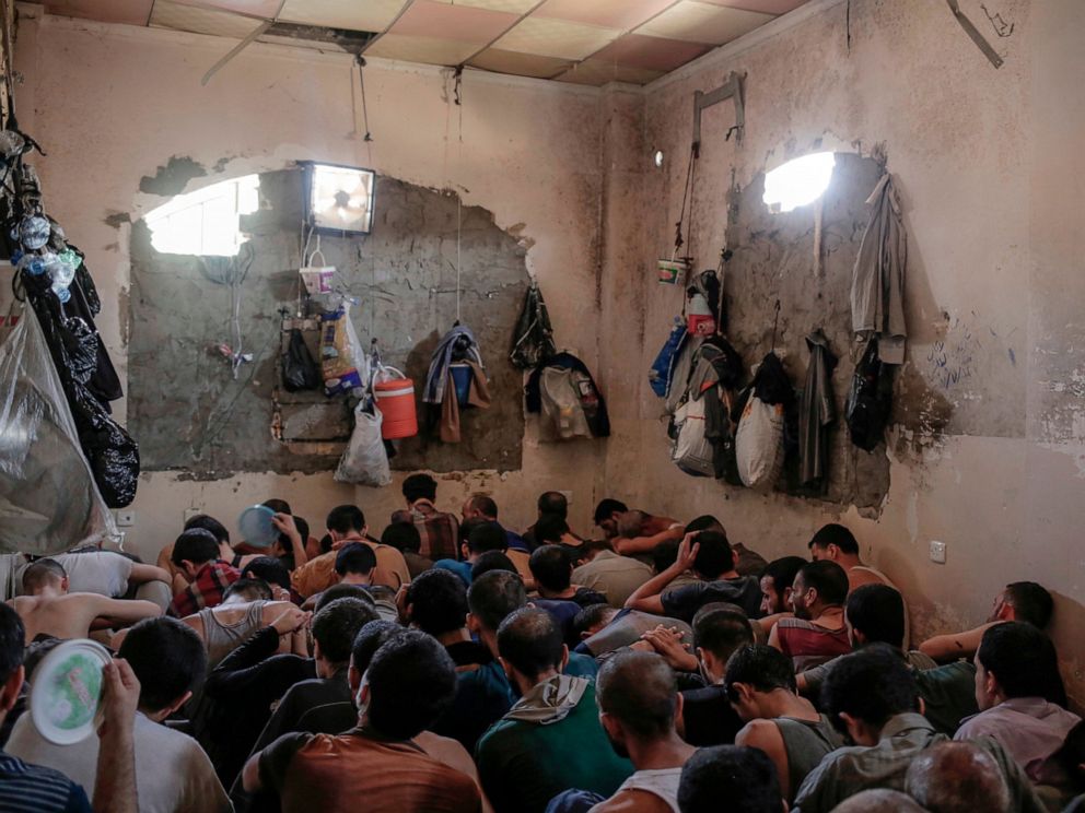 PHOTO: In this Tuesday, July 18, 2017 file photo, Suspected Islamic State members sit inside a small room in a prison south of Mosul, Iraq.