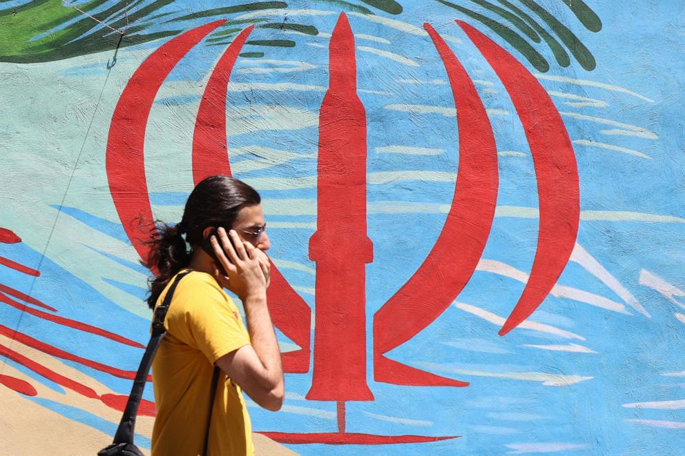 PHOTO: An Iranian man walks past an anti-U.S. and anti-Israel mural painted on a wall, in the capital Tehran, on May 10, 2026.